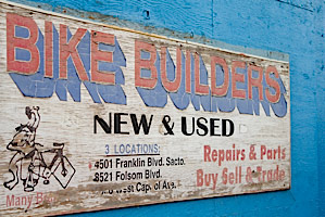 vintage bike builders flea market sign on a blue wall